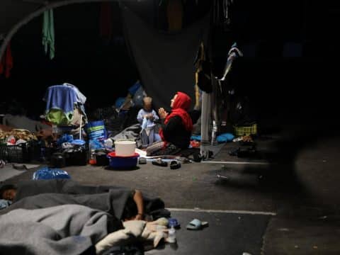 Edgy locals patrol streets in wake of devastating refugee camp blaze