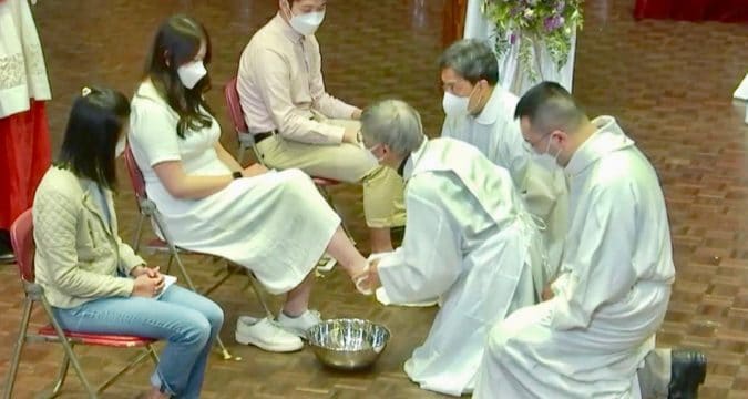Bishop Chow washes the feet of young people on Holy Thursday