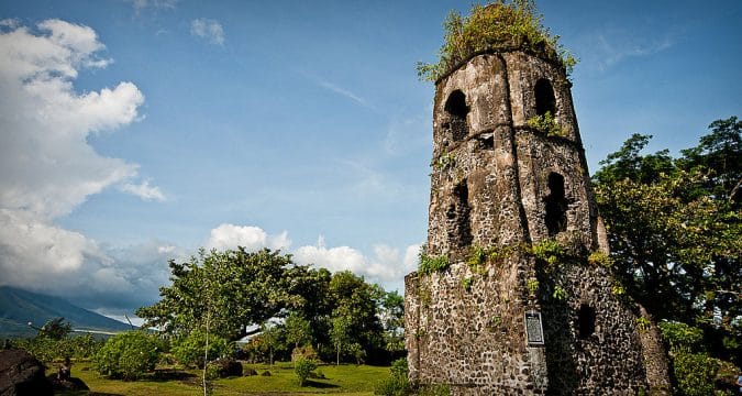 In the shadow of the volcano centuries old church tower stands tall