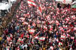 Demonstrators stand next to Lebanese army soldiers during ongoing anti-government protests in Jal el Dib, Lebanon, on October 23. Photo: CNS/Reuters