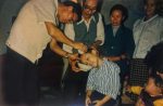 Father Yu baptises a child during one of his visits to China.