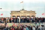 People stand atop a section of the Berlin Wall in front of the Brandenburg Gate on 10 November 1989. File photo: CNS/Reuters