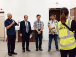 Father Peter Leung, left speaking to parishioners and the press on November 11.
