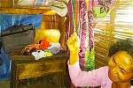 Wihelmina Jemima cries as she holds the rope her daughter, Elvina Arce, used to commit suicide herself. Photo:UCAN