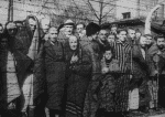 The haunted faces of men, women and children look on from behind barbed wire after the liberation of the Auschwitz-Birkenau death camp in 1945 in Oswiecim, Poland. File photo: CNS/Yad Vashem Archives via Reuters