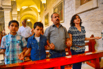 A family prays during Mass in the Church of St. Catherine in Bethlehem, West Bank. Photo: CNS