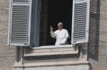 Pope Francis is seen in a window greeting a few nuns standing in St. Peter's Square at the Vatican on March 22 after reciting his weekly Angelus prayer from the library of the Apostolic Palace. Photo: CNS/Reuters