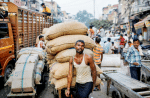 A migrant worker pulls his handcart loaded with spices through a traffic jam at a wholesale market in New Delhi in October 2019. The Church in India has been gearing up to face the Covid-19 coronavirus pandemic. Photo: CNS/Reuters