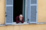 A man at the window of his apartment during a musical flash mob in Rome, Italy, on March 12. People have been coming to their windows to hear an uplifting song or to entertain each other. The nationwide effort to lift morale came as Italy endures a near total lockdown in a bid to slow spread of the Covid-19 coronavirus. Photo: CNS