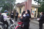 Priests and nuns offer medical masks to students in front of a high school in Vietnam’s Thai Binh province on March 6. Photo: UCAN/ courtesy Nguyen Ngoc Nam Phong’s Facebook page