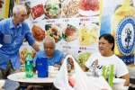 Father Wotherspoon (standing) with McRefugees at one of the Thursday Dinners MercyHK hosts for them. File photo: UCAN