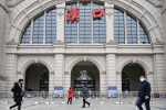 People walk past the closed Hankou Railway Station in Wuhan after the city was locked down following the Covid-19 outbreak on January 23. Photo: CNS/China Daily via Reuters