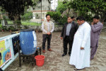 Bishop Indrias Rehmat of Faisalabad (second from right), with Father Abid Tanveer, vicar general of Faisalabad, and Aneel Mushtaq (left) at the installation of a hand-washing facility at the entrance to the Cathedral of Ss. Peter and Paul. Photo: UCAN/Aneel Mushtaq