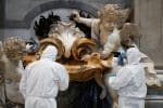 Vatican staff members in protective gear sanitise the holy water font inside St. Peter's Basilica at the Vatican on May 15, ahead of the resumption of Masses during the Covid-19 pandemic. Photo: CNS / Reuters