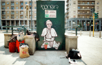 A mural depicting Pope Francis as a homeless man asking for charity seen in Milan on May 23. Photo: CNS/Reuters