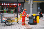 A street cleaner in protective gear sanitises a trash can in Beijing on May 18. Photo: CNS/Reuters