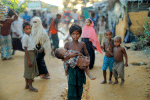 A young Rohingya refugee carries a child while walking at a camp near Cox's Bazar, Bangladesh. Photo: CNS photo/Reuters