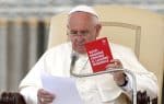 Pope Francis holds a pamphlet for the Red Card to Child Labour campaign during his June 11 general audience in St. Peter's Square The words on the pamphlet in Italian say: "All together against child labour." Photo: CNS