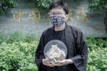 Netiwit Chotiphatphaisal outside the Chinese embassy in Bangkok with a box of commemorative cookies on June 4. Photo: UCAN/courtesy of Netiwit Chotiphatphaisal