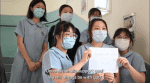 Students hold placards expressing support for the Maryknoll Fathers in the United States. Photo: Screenshot from Maryknoll Fathers’ School website