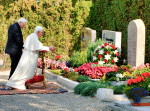 Monsignor Ratzinger and now-retired Pope Benedict, at their parents’ grave in Pentling, Germany, in 2006. Photo: CNS/KNA