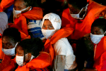 Rescued migrants look out from an Armed Forces of Malta vessel upon their arrival in Valletta, Malta, on August 3. Photo: CNS/Reuters
