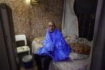 A man sits inside his dwelling in Mato Grosso, Brazil, on August 28, 2020. "Enough of misery, prejudice and repression! We want work, land, housing and participation!" was the theme of this year's Cry of the Excluded, sponsored by the Brazilian bishops' conference. Photo: CNS/, ECLAC, Latin America News Agency via Reuters
