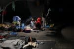 A woman displaced from the destroyed Moria refugee camp prays in the parking lot of a supermarket on the Greek island of Lesbos on September 15. Photo: CNS/Reuters