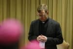 Father Zollner prays during the 2019 meeting at the Vatican on protecting young people in the Church. Photo: CNS