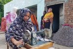 A woman stitches garments at the shelter house in flooded Balkana village in Punjab province. Photo: UCAN/Kamran Chaudhry
