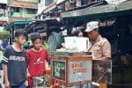 Children and a vendor in a densely populated area of Jakarta not wearing face masks despite warnings to do so because of Covid-19. Photo: UCAN/Siktus Harson