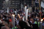 Protesters hold torches during a demonstration in Beirut on October 17, marking the anniversary of Lebanon’s massive popular uprising against the corrupt political class. Photo: CNS/Reuters
