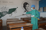 A student disinfects classrooms at Cristal University. Photo: UCAN
