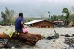 A man looks at his house buried under a pile of rubble and sand in Daraga, the Philippines, following flash floods brought by Super Typhoon Goni. Photo: CNS/Reuters