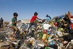 Iraqi boys collect recyclable garbage at a dump in Najaf, Iraq. Photo: CNS
