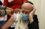A health care worker vaccinates an elderly man against Covid-19 in Jerusalem on December 21. Photo: CNS/Reuters