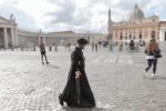 A priest wearing a surgical facemask walks along a street just outside St. Peter’s Square at the Vatican on October 12. Photo: CNS/Reuter