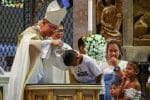 Cardinal Luis Tagle baptises a boy in Manila in September 2019. Authorities in the Philippine capital are banning children from public places including churches in a bid to curb the spread of Covid-19. File photo: UCAN