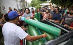 Relatives of Covid-19 patients who are hospitalised or receiving health care at home gather to buy oxygen at a private company in Manaus, Brazil, on January 15. Photo: CNS/Reuters