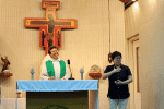 Peggy Fung signing for the hearing-impaired during a Mass.
