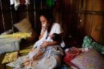 A sick woman holds her baby. File photo: UCAN/Sharlene Festin