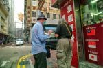 Father John gives food coupons to a homeless person in the Jordan district of Hong Kong on March 6. Photo: CNS/stringer