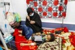 A child who was diagnosed with Covid-19 with her mother in the quarantine ward at a hospital in the holy city of Najaf, Iraq, on February 25. Photo: CNS/Reuters