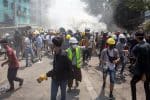 Protesters retreat after police opened fire to disperse an anti-coup protest in Mandalay, Myanmar, on March. Photo: CNS/Reuters