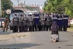 Sister Ann Nu Thawng kneels in front of police and soldiers, imploring troops to not shoot civilians during an anti-coup protest in Myitkyina, Myanmar, February 28. Photo: CNS/courtesy Myitkyina News Journal