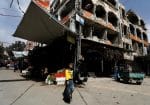 A boy walks past damaged buildings in Douma, Syria, on March 10, 2021. Photo: CNS/Reuters