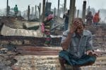 A Rohingya refugee squats amid debris of burned shelters at the Nayapara refugee camp in Cox's Bazar, Bangladesh, on January 14. Photo: CNS / Reuters