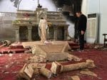 A priest stands inside Catholic church desecrated by Islamic State militants in Karamdes, Iraq, in 2016. Photo: CNS/courtesy Archdiocese of Irbil