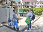 Members of the labour commission and Father Lam (second from left) visit a cleaning worker in Fanling on May 1.