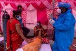 A woman surrounded by her relatives receives oxygen support for free at a Sikh temple in Ghaziabad, India, on May 6. Photo: CNS/Reuters